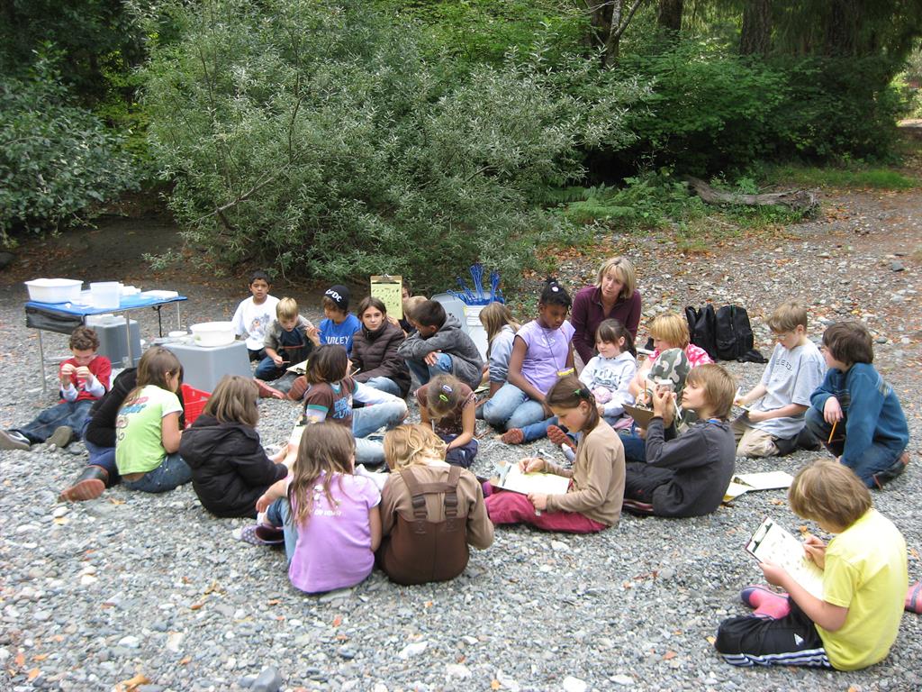 children gathered looking at clip boards