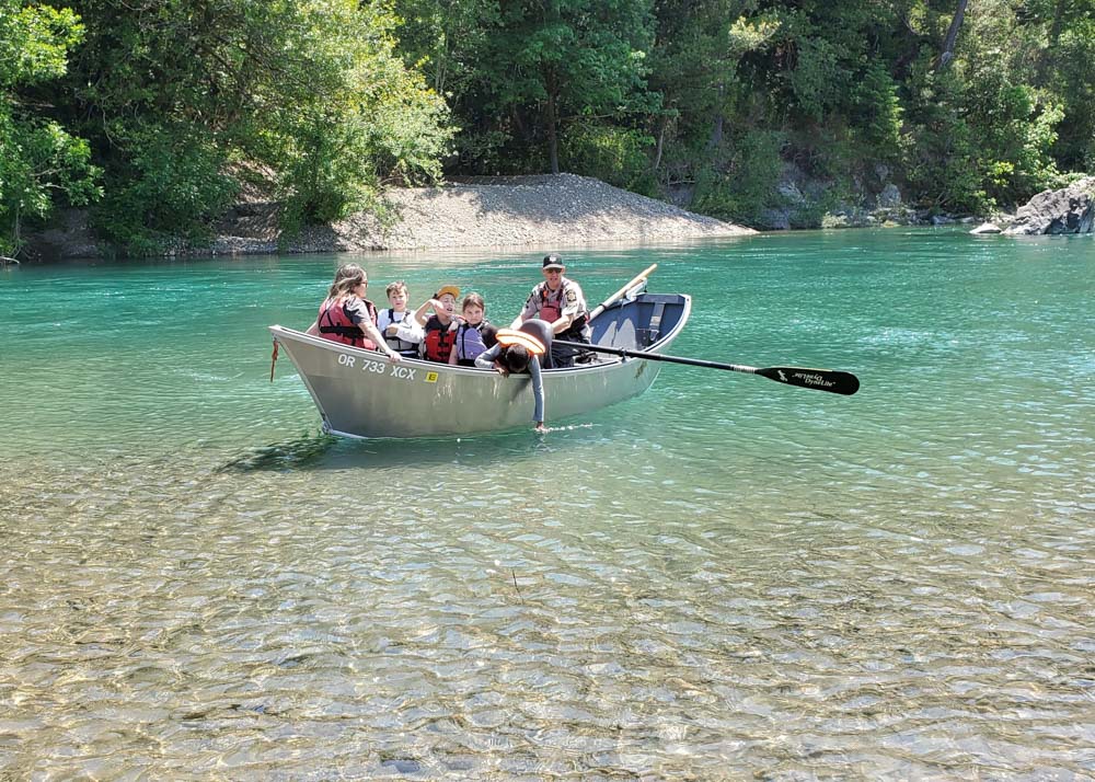 children in a drift boat