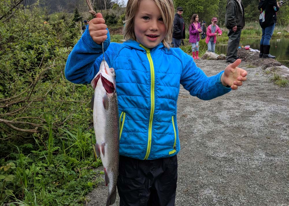 child holding a large fish