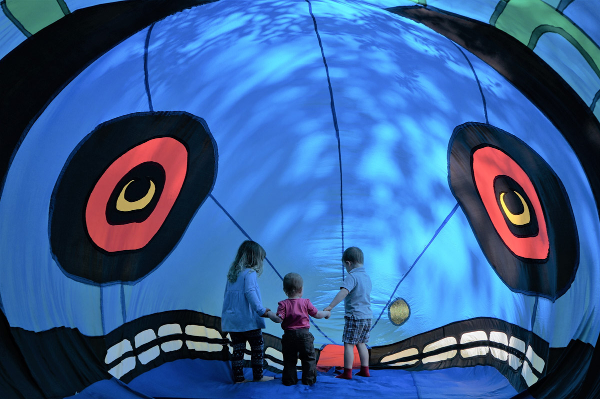 children looking at large artwork